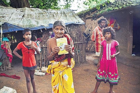 Devki Devi, grandmother of 11-year-old Santoshi Kumari, who allegedly died of hunger last year, shows her Aadhaar card, as Santoshi’s sister Janki Devi (R) looks on | Mukesh ranjan