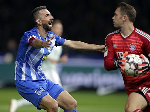 Bayern goalkeeper Manuel Neuer catches the ball as Hertha's Vedad Ibisevic reacts after missing to score during their German Bundesliga clash | AP