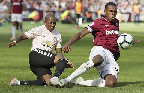 West Ham's Issa Diop, right, challenges Manchester United's Ashley Young, left, during the English Premier League soccer match between West Ham United and Manchester United at London Stadium. (Photo | AP)