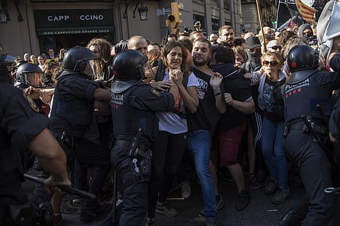 Catalan police officers clash with pro independence demonstrators on their way to meet a demonstrations by member and supporters of National Police and Guardia Civil in Barcelona. (Photo | AP)