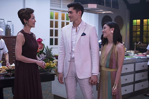 This image released by Warner Bros. Entertainment shows Michelle Yeoh, from left, Henry Golding and Constance Wu in a scene from the film 'Crazy Rich Asians.' (Sanja Bucko/Warner Bros. Entertainment via AP)