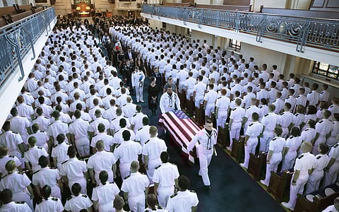John McCain's family follows as the casket is moved from the Chapel on the grounds of the United States Navel Academy. (Photo | AP)