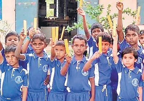 Students with wooden rulers