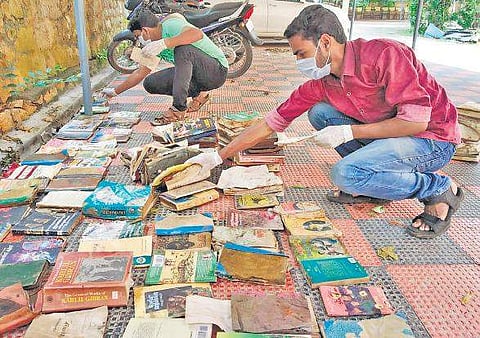 Archives Department staff drying the books recovered from Kodungallur