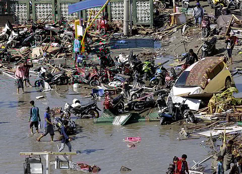 People survey damage outside the shopping mall following earthquakes and tsunami in Palu, Central Sulawesi, Indonesia. (Photo | AP)