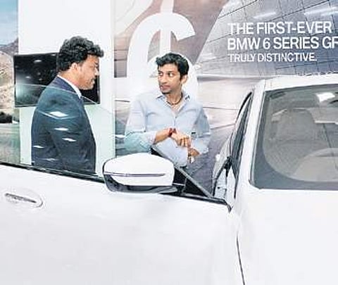 Narain Karthikeyan, India’s first F1 driver, checks out a car | Express