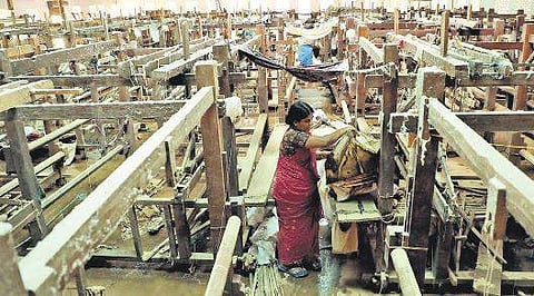 Workers engaged in cleaning at the Chendamangalam Handloom Weavers Co-operative Society which was flooded Melton Antony