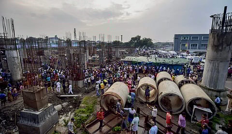 People gather near the site where a section of Majerhat bridge collapsed in Kolkata Tuesday September 04 2018. | PTI
