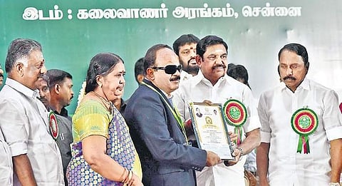 CM Palaniswami honours a teacher with Dr. Radharkrishnan Award in the city on Teachers’ Day while Deputy CM O Panneerselvam looks on | P Jawahar