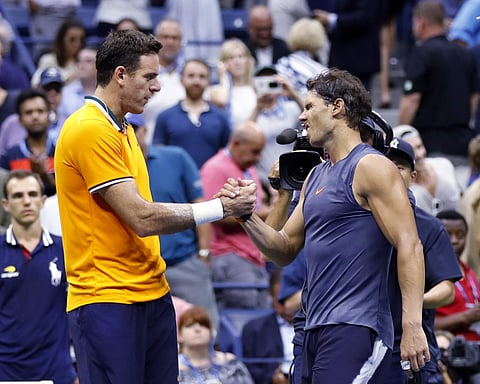 Juan Martin del Potro, of Argentina, shakes hands with Rafael Nadal, of Spain, after Nadal retired from the match during the semifinals of the U.S. Open tennis tournament. (AP)
