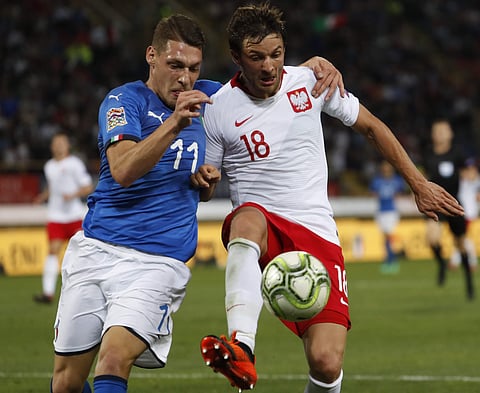 Italy's Andrea Belotti and Poland's Bartosz Bereszyński, right, vie for the ball during the UEFA Nations League soccer match between Italy and Poland at Dall'Ara stadium in Bologna, Italy, Friday, Sept. 7, 2018. | AP