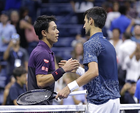 Novak Djokovic, of Serbia, shakes hands with Kei Nishikori, of Japan, after Djokovic defeated Nishikori during the semifinals of the U.S. Open tennis tournament, Friday, Sept. 7, 2018, in New York. | AP