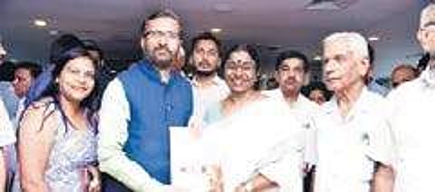 KSLMA director P S Sreekala hands over the Literacy Mission’s project report to HRD Minister Prakash Javadekar on the sidelines of a panel discussion on International Literacy Day at the Pravasi Bharatiya Kendra in New Delhi on Saturday. Secretary of Depa