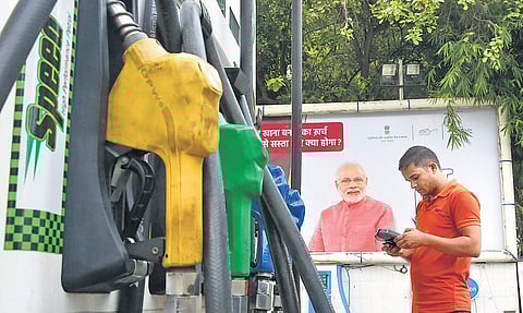 A customer makes payment at a petrol pump in New Delhi on Saturday. Petrol price reached B80.44 per litre in the National Capital | SHEKHAR YADAV