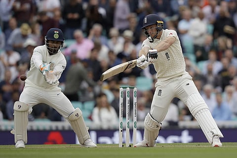 England's Jos Buttler hits a shot next to India wicketkeeper Rishabh Pant during the fifth cricket test match of a five match series between England and India at the Oval cricket ground in London, Saturday, Sept. 8, 2018. | AP