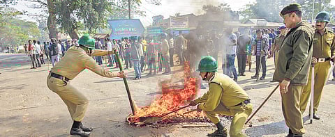 Policemen control a fire set by agitators protesting against the Citizenship Bill in Tripura. Image used for representational purpose only. (Photo | PTI)