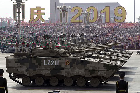 Military vehicles roll down as members of a Chinese military honor guard march during the parade to commemorate the 70th anniversary of China. ( Photo | AP )
