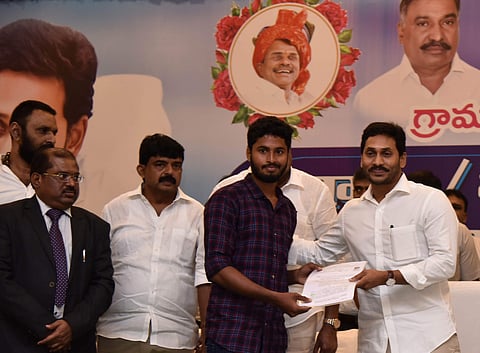 Andhra Pradesh CM YS Jagan Mohan Reddy hand overs appointment letters to Village Secretaries at A plus convention in Vijayawada on Monday. | (Photo | EPS)