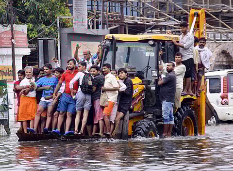 Residents ride a municipality earth-mover through a flooded street following heavy monsoon rain in Patna Monday Sept. 30 2019. | (File | PTI)