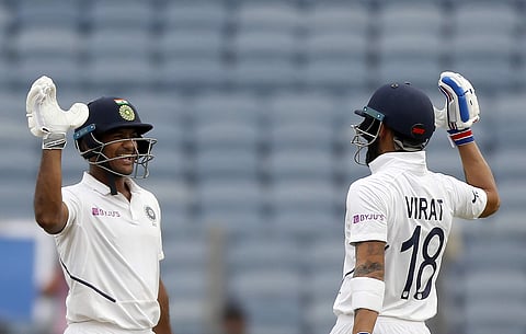 India's Mayank Agarwal, left, celebrates scoring a century with captain Virat Kohli. (Photo | AP)