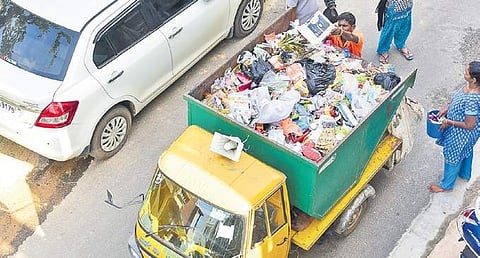A BBMP worker collects garbage from homes in Bengaluru on Tuesday | Vinod Kumar T