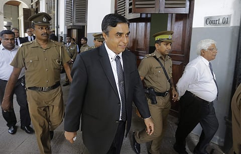 Sri Lankan police chief Pujith Jayasundara, center, who has been sent on compulsory leave following Easter Sunday attacks, walks out of a High Court with prison officers in Colombo, Sri Lanka, Wednesday, Oct. 9, 2019. (Photo | AP)