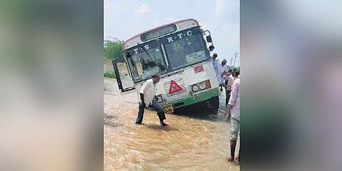 The RTC bus seen partially stuck in the Dundubhi river canal (Photo |EPS)