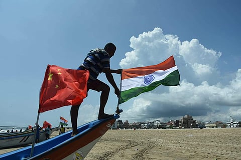 Fishermen's at Palavakkam beach tie two national flags on their boats in welcoming the Chinese president and Indian Prime Minister to Chennai on Thursday (Photo | Ashwin Prasath, EPS)