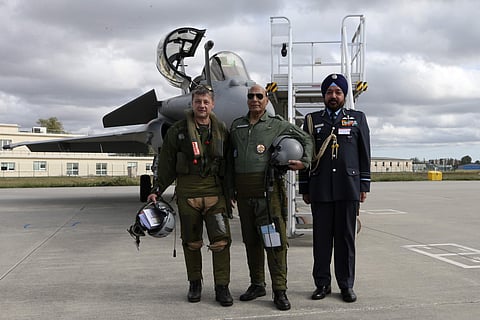 Rajnath Singh, center in a military outfit, poses in front of a Rafale jet fighter during an handover ceremony at the Dassault Aviation plant in Merignac, near Bordeaux, southwestern France, Tuesday, October 8. (Photo | AP)