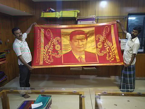 The Chinese President was seen unfurling the shawl to get a full view of his portrait knitted in it. (Photo | EPS)