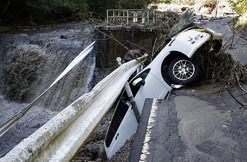 A vehicle falls off collapsed road in the typhoon-hit Kakuda city, northern Japan (Photo | AP)