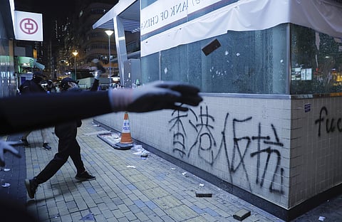Protestors vandalize a subway entrance in Hong Kong (Photo| AP)