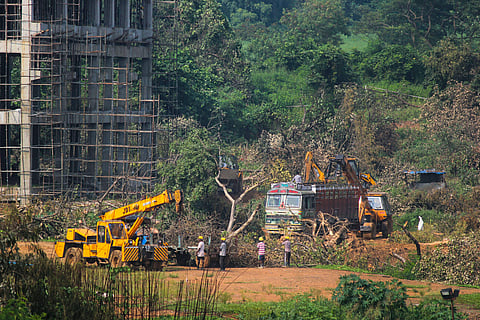 A crane lifts the the fallen trees to be carried away for building a construction site of metro car parking shed at Aarey Colony Mumbai Monday Oct. 7 2019. | (Photo | PTI)
