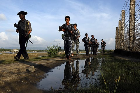 Myanmar police officers patrol along the border fence between Myanmar and Bangladesh in Maungdaw, Rakhine State, Myanmar (File Photo | AP)