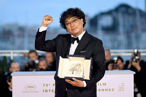 Bong Joon-Ho shows off his Palme d'Or prize in Cannes. (Photo | File, AFP)