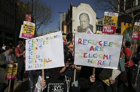 Demonstrators chant with placards as they march during an anti-racism protest called by the 'Stand Up To Racism' group in Croydon, south London (File photo| AFP)