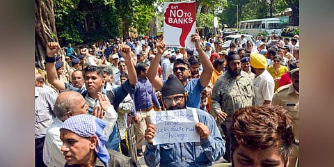 PMC Bank customers stage a protest outside the Killa Court in Mumbai. (Photo | PTI)