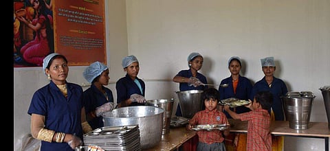 Mothers serving mid-day meals to children of Adani Vidya Mandir (Photo | EPS)