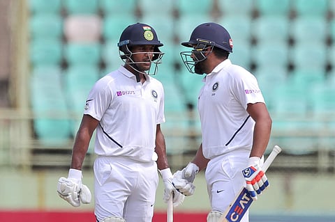India's Rohit Sharma, right, and Mayank Agarwal, left, cheer each other as they bat. (Photo | AP)
