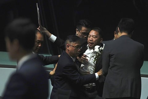 A pro-democracy lawmaker is taken away as he shouts a slogan while Hong Kong Chief Executive Carrie Lam arrives at chamber of the Legislative Council in Hong Kong (Photo| AP)