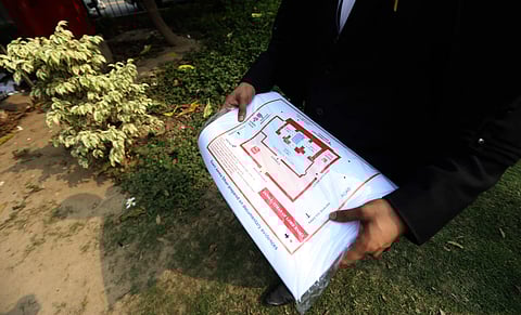 A lawyer holds a map calmed to be original site of Ram Janam Bhumi that was tore during Ram janmbhumi-Babri Masjid Case at Supreme Court. ( Photo | Arun Kumar, EPS )