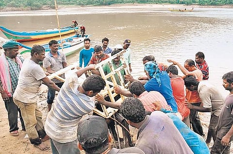 Team of marine experts, led by Dharmadi Satyam, bringing out the iron railing of Royal Vasishta from River Godavari at Kachaluru in East Godavari district on Thursday | Express