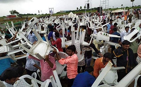 Workers clear the chairs from a private ground on Thursday, after Chief Minister K Chandrasekhar Rao’s proposed visit to Huzurnagar was cancelled due to heavy rains (Photo |EPS)