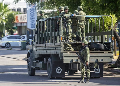 Mexican soldiers patrol around the city a day after a gun battle between gunmen and security forces in Culiacan. (Photo | AP)