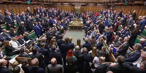 Britain's Prime Minister Boris Johnson, centre left, begins to stand, to deliver a statement to lawmakers inside a crowded House of Commons in London. (Photo | AP)