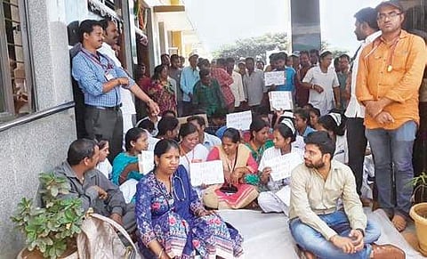 Doctors and staff stage a protest against manhandling of a doctor in Vizag Agency on Tuesday | express