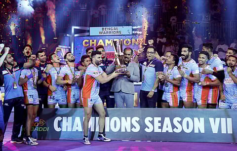 Players and officials of Bengal Warriors celebrate with the trophy after defeating Delhi Dabbang KC during the finals of the seventh edition of Pro-Kabaddi league in Ahmedabad Saturday Oct. 19 2019. | (Photo | PTI)