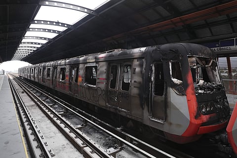 Subway cars burnt by protesters are parked at the Elisa Correa station in Santiago, Chile. (Photo | AP)