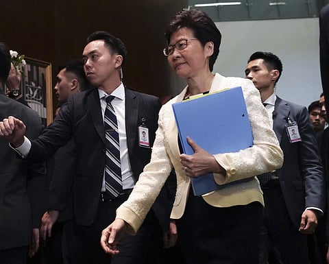 Hong Kong Chief Executive Carrie Lam, center, arrives at chamber of the Legislative Council in Hong Kong. Hong Kong is feuding with Taiwan over a fugitive murder suspect whose case indirectly sparked the protests in Hong Kong over an extradition bill. (Ph