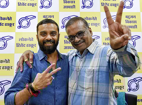 Hitendra Thakur, president of Bahujan Vikas Aaghad, celebrates with his son Kshitij Thakur after winning the assembly election at Virar, Mumbai. (Photo | PTI)